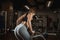 Young woman lifting barbell with light weights at gym. Fitness female doing crossfit workout