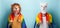 Young woman in lion and alpaca mask hold rainbow lgbt pride flag wrapped around the shoulders