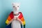 Young woman in lion mask proudly hold rainbow lgbt pride flag wrapped around the shoulders