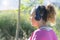 Young woman listening music on a wireless headphones while being outdoors with sportswear. Runner concept