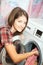 Young woman loading the washing machine