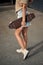 Young Woman With Longboard. Girl skater posing on longboard in sunny weather