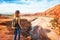 Young woman looking at beautiful landscape. Nature of Morocco view from above. Traveler girl stands on a rock looks up