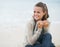 Young woman looking on copy space while sitting on beach