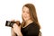 Young woman looking down at an antique camera