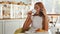 Young woman looking excited, talking on the phone while having coffee