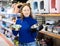 Young woman looking for food bowl for dog in pet store