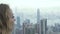 Young woman looking Hong Kong city panorama from Peak Victoria. Portrait tourist caucasian woman watching panoramic view