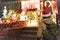 Young woman looking on house decorated for Christmas and New Year with glowing garlands in the Dyker Heights neighborhood, New