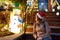 Young woman looking on house decorated for Christmas and New Year with glowing garlands in the Dyker Heights neighborhood, New