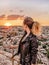 Young woman looking at sunset. Cappadocia viewpoint.