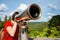 Young woman looking through tourist telescope