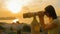 Young woman looking through tourist telescope, exploring historical part of city