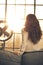 Young woman looking in window in loft apartment