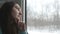 Young woman looking on window during riding on train. Profile of attractive girl traveling on railroad at winter time