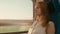 Young Woman is Looking by the Window at Sunset while Traveling by Train