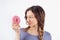 Young woman looks at a donut. Concept of diet