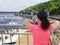 Young woman looks at the embankment, bridge and river