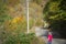 A young woman looks the forest in autumns,