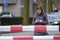 Young woman looks on her mobile at a railroad crossing