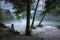 Young woman lost in misty confluence of Soca and Tolminka river in Slovenia