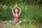 Young woman in lotus position in park