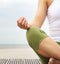 Young woman in lotus position with yoga hands