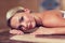 Young woman lying on hammam table in turkish bath