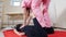 Young woman lying on the mat and receiving the thai massage. Stretching muscles