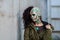 Young woman with makeup of green skull for halloween