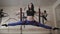 Young woman making antigravity yoga twine exercises with red hammock in dance studio