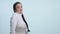 Young woman making do not know sign on white background