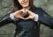 Young woman making her hands in heart shape. Heart health insurance, social world heart day