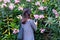 Young woman making image of flowers