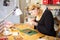 Young Woman Making Jewelry At Home