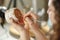 Young woman making pottery indoors at creative studio craftsperson concept sitting at table using modeling tool creating