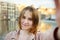 Young woman making a self portrait selfie with famous dancing houses of Amsterdam on background