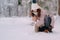 Young woman making snowball hands in park