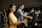 Young woman and man on elliptical stepper trainer exercising in gym