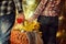 Young woman and man holding a basket with blanket, yellow leaves coffee, close-up.