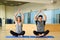 Young woman and man practicing yoga indoors