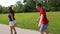 Young woman and man rollerblading on a beautiful sunny summer day in park, holding waist