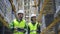 Young woman and man are talking and walking at warehouse during working day.