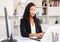 Young woman manager with laptop and documents at office