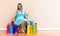 Young woman with many brightly colored shopping bags