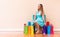 Young woman with many brightly colored shopping bags