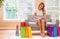 Young woman with many brightly colored shopping bags