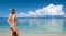 Young woman with mask going to snorkel in tropical beach