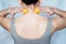 Young woman massages her neck with trigger point tennis ball used for muscle pain releive and myofascial release