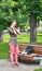 Young Woman Massaging her Nape in a Park